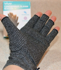 Wearing Vive Arthritis Glove palm up showing the textured grip design