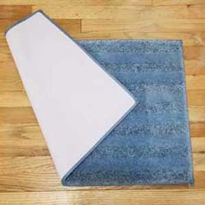 Blue non-slip bath mat folded over to show non-slip backing